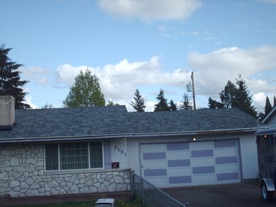 Garage and driveway with new roof and stonework